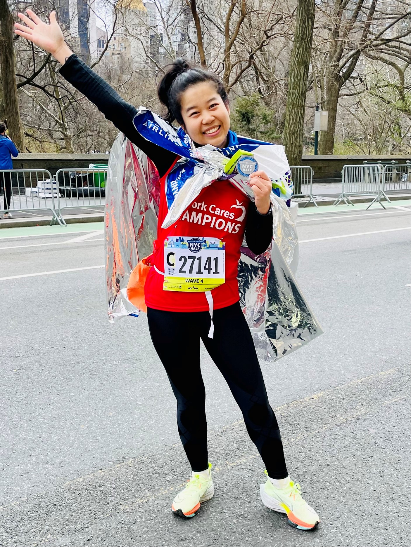 Cares Champion United Half Marathon runner smiling at the camera with medal