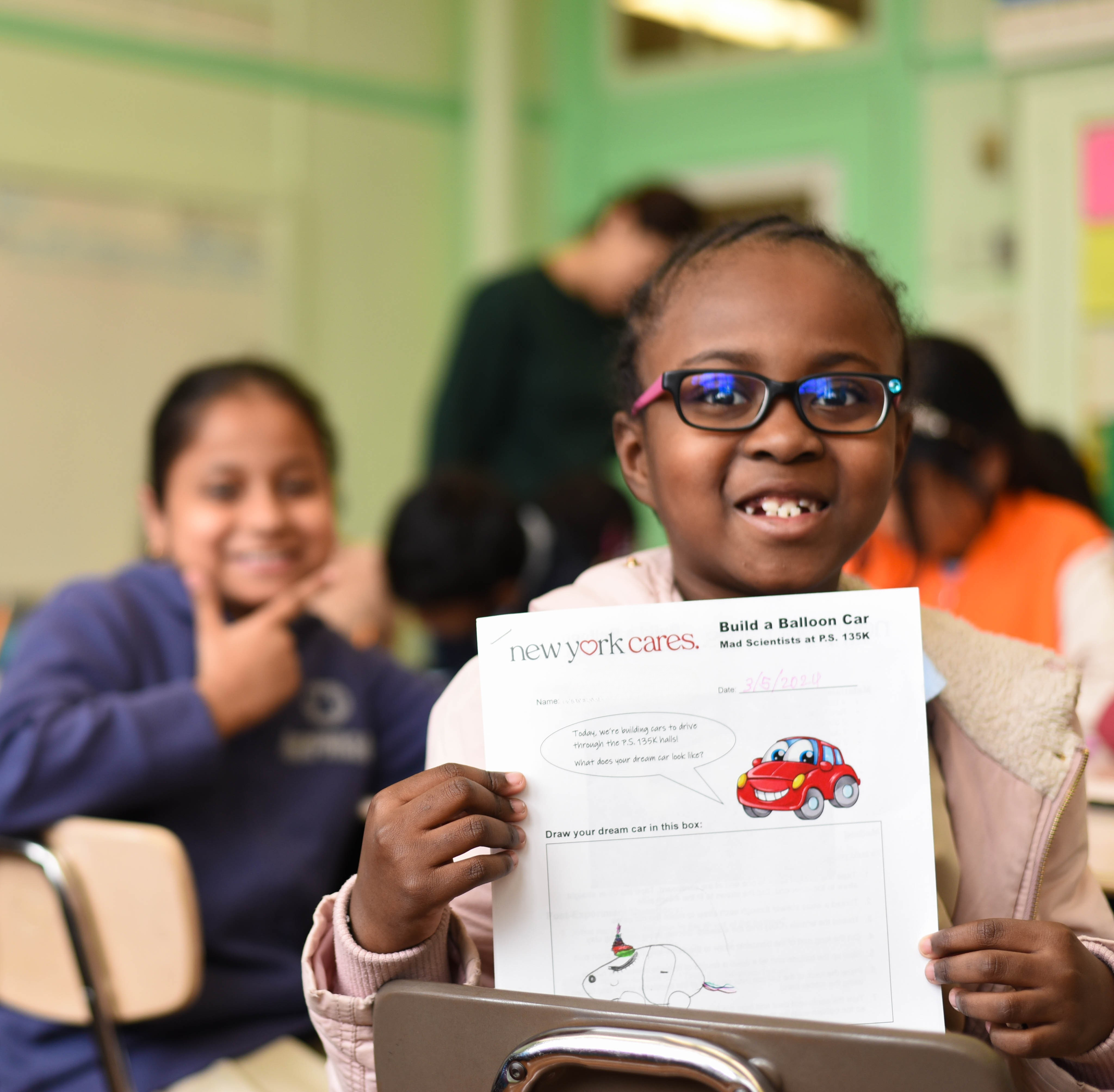Children at school showing a letter to New York Cares